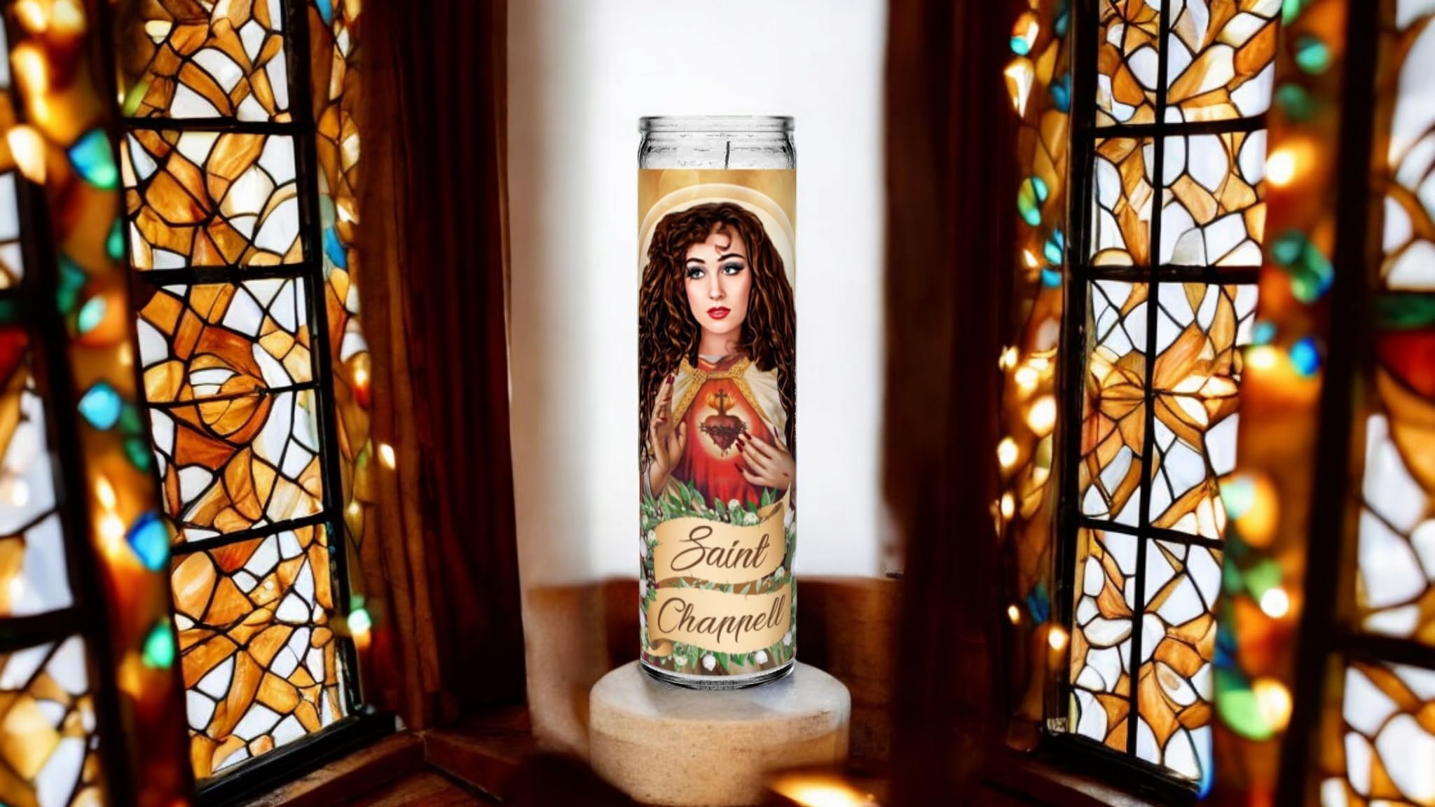 This image shows the Saint Chappell Roan Prayer Candle, beautifully set against stained glass windows with warm and vibrant colors. The candle features an illustration of Chappell Roan dressed in a saintly robe, with a glowing Sacred Heart symbol in the center of her chest. The intricate detailing around the candle, including floral accents and a halo-like design, gives it a divine and reverent touch while capturing Chappell Roan's essence.